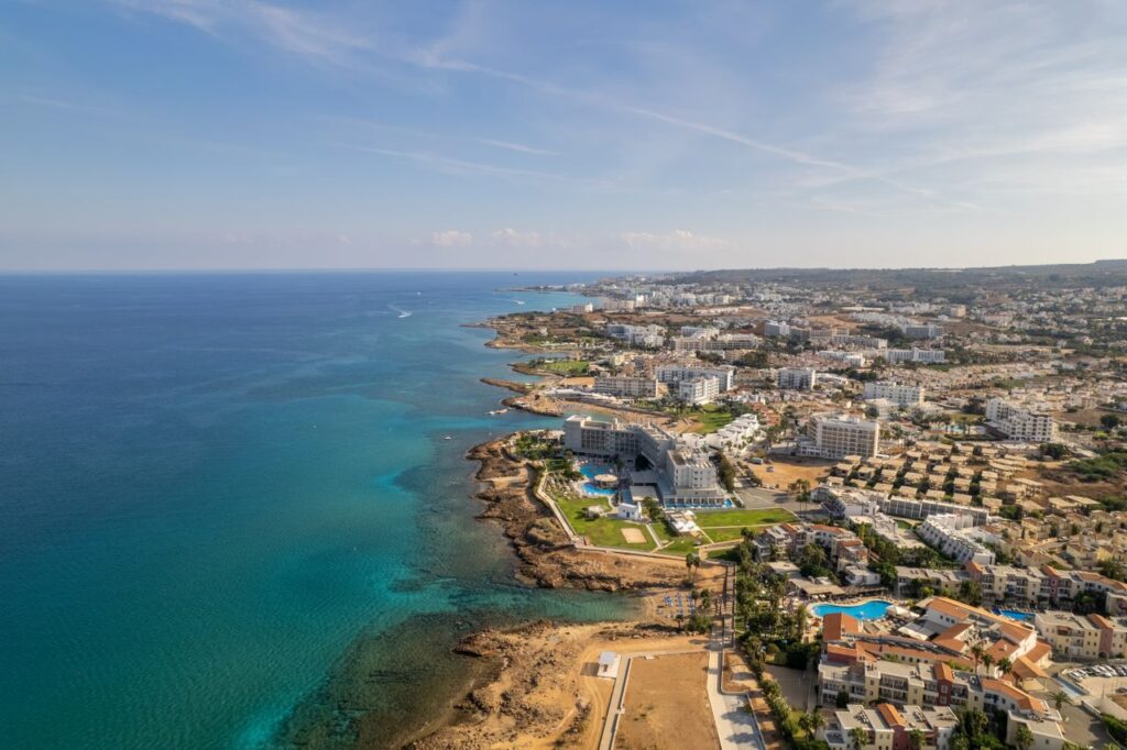 Stunning aerial view of Protaras coastline showcasing resorts, beaches, and crystal-clear waters in Cyprus.